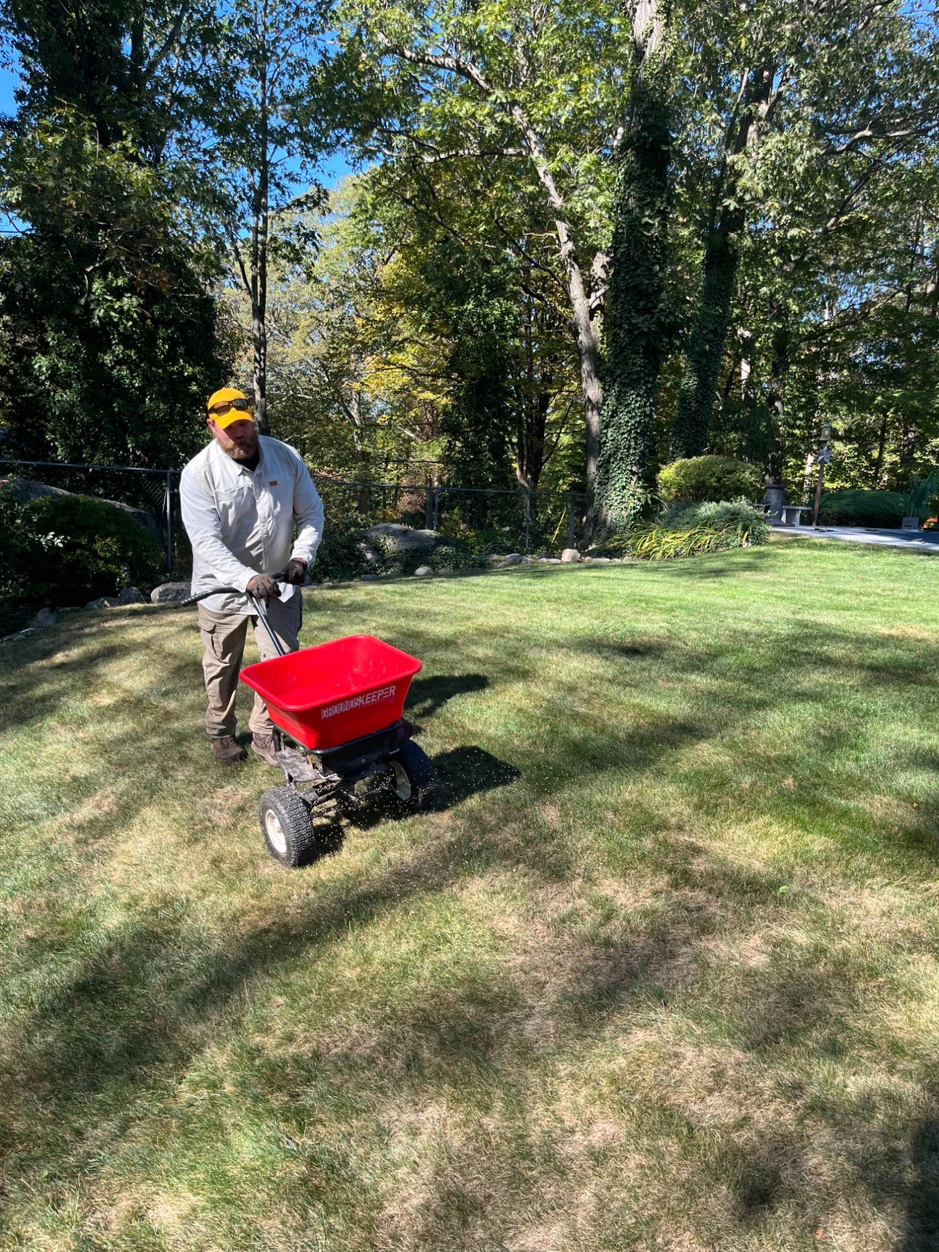 Pops Pest Control team applying lawn fertilizer treatment
