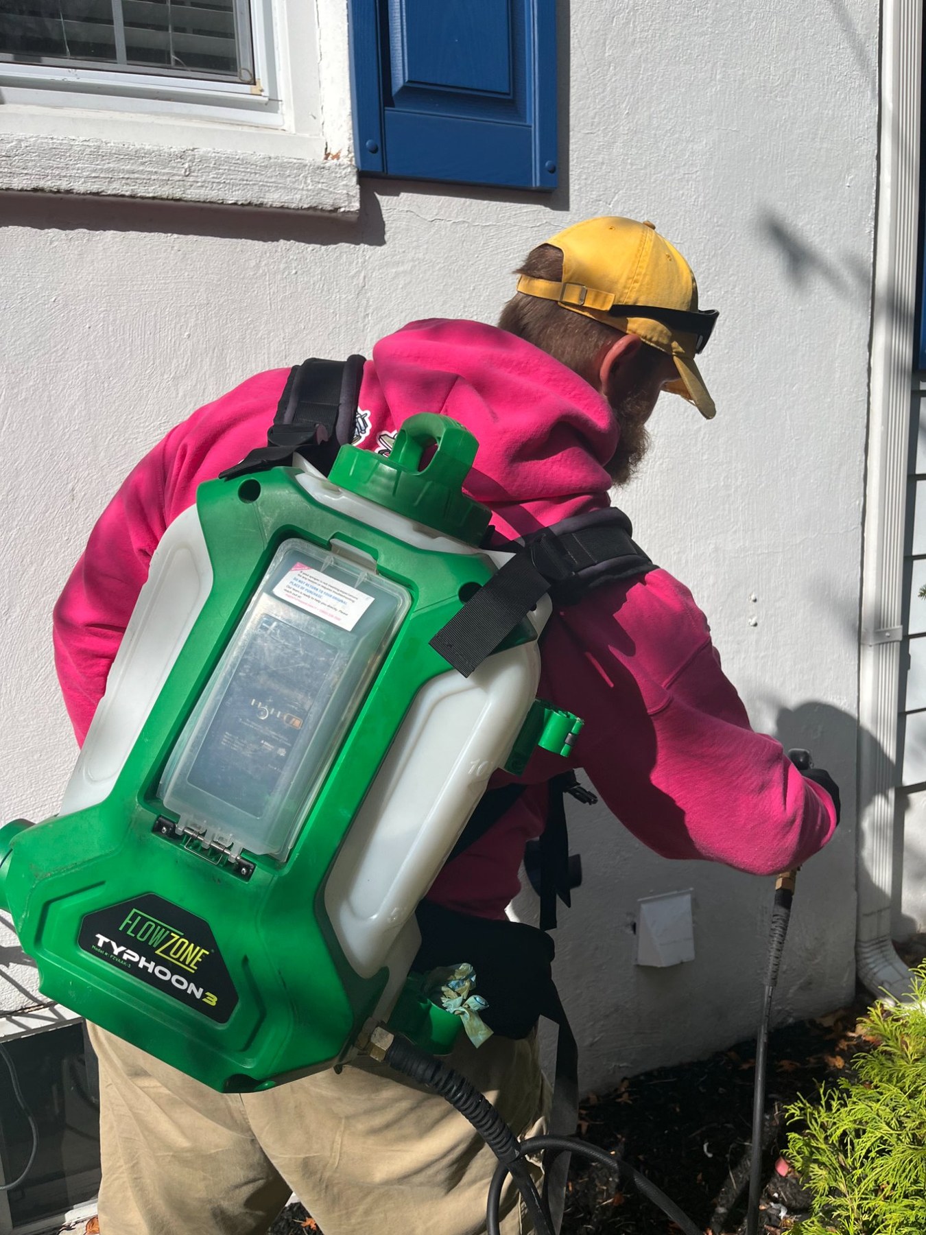 Pops Pest Control team applying perimeter pest treatment